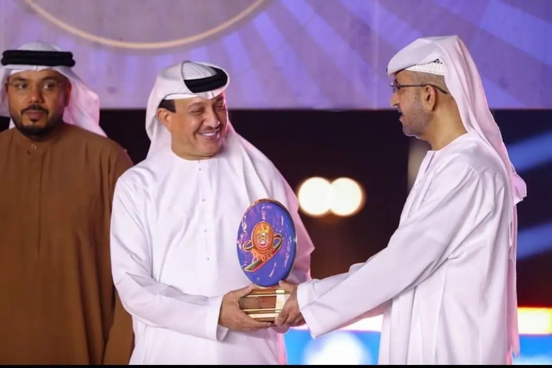 Circular award exchanged at a formal presentation