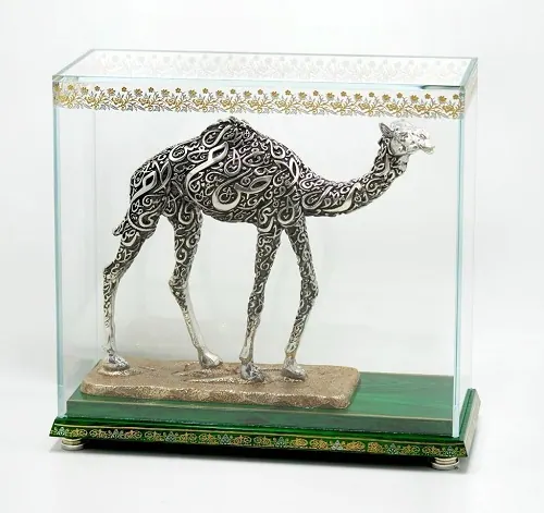 Filigree camel sculpture shown inside its display case