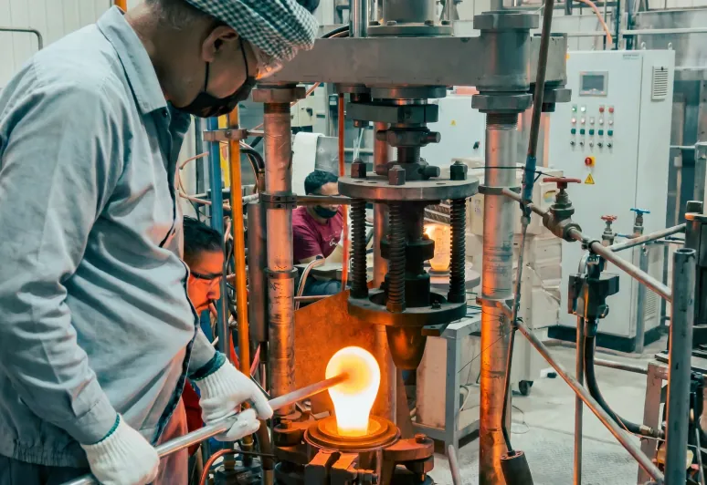 Molten crystal being worked into a mould under the press