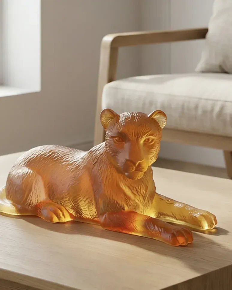 Reclining lioness sculpted in amber crystal
