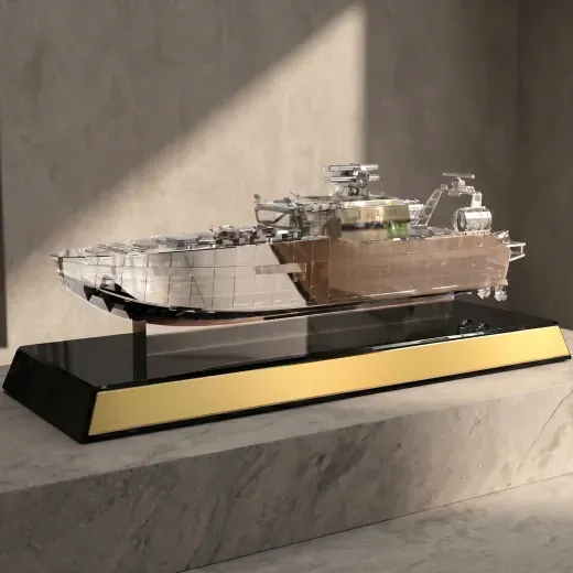 Detailed ship model on a black and gold base